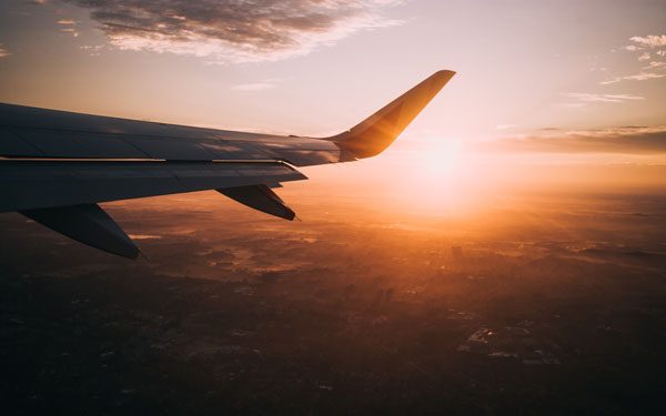 Wing of the plane flying to Madrid at sunset